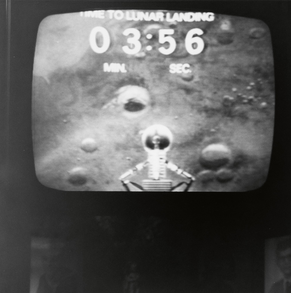 (TELEVISION) Small album with 35 snapshots of a television screen as Apollo 11 made its historic moon landing.
